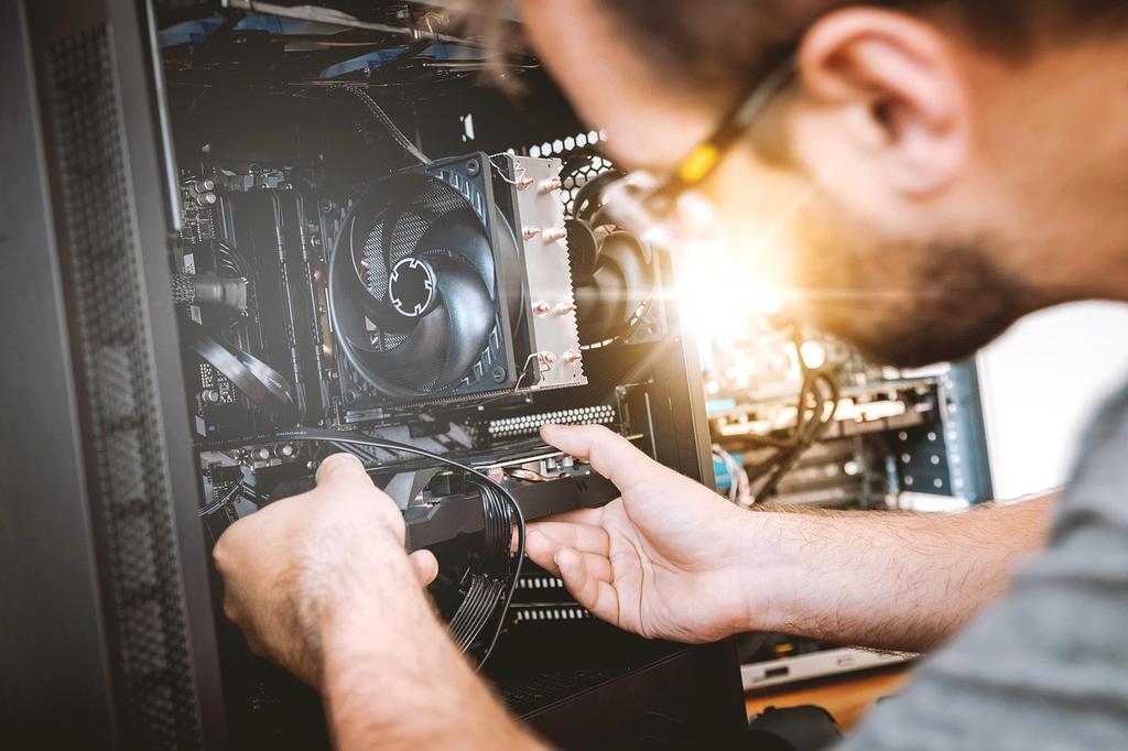 Close-up of technician repairing motherboard